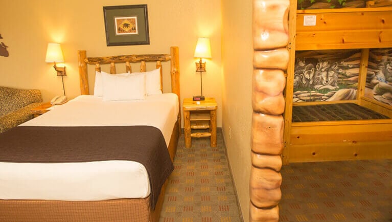 The bed and indoor cabin with bunk beds in the Wolf Den Suite 